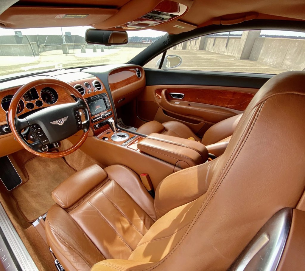 The tan-leather and wood-trimmed interior of a 2007 Bentley Continental GT