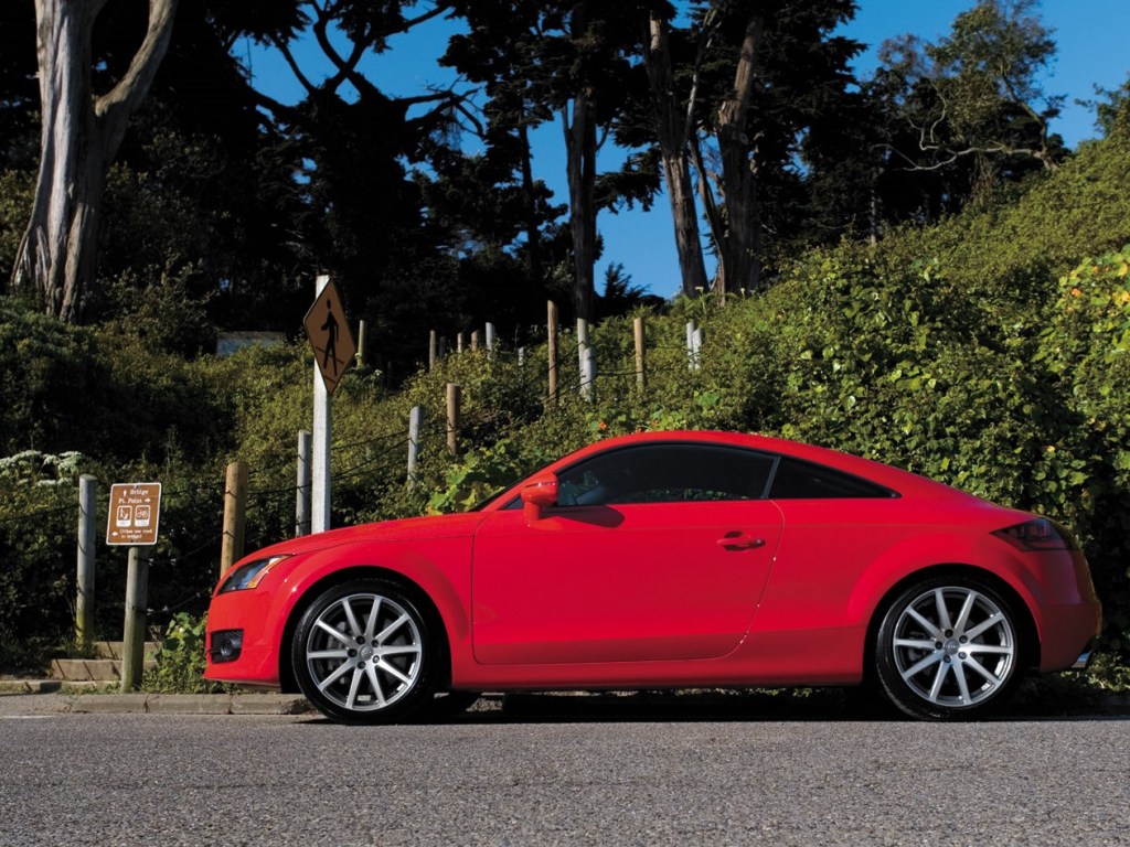 A red Audi sports car sits at an intersection.