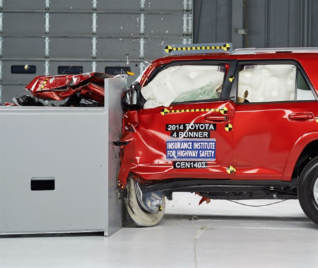 A red 2014 Toyota 4Runner SUV getting crash tested for safety