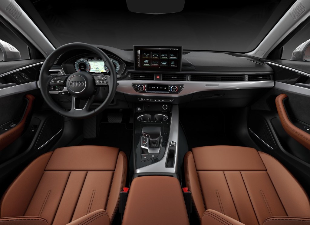 The brown-leather front seats and silver-and-black dashboard of the 2020 Audi A4