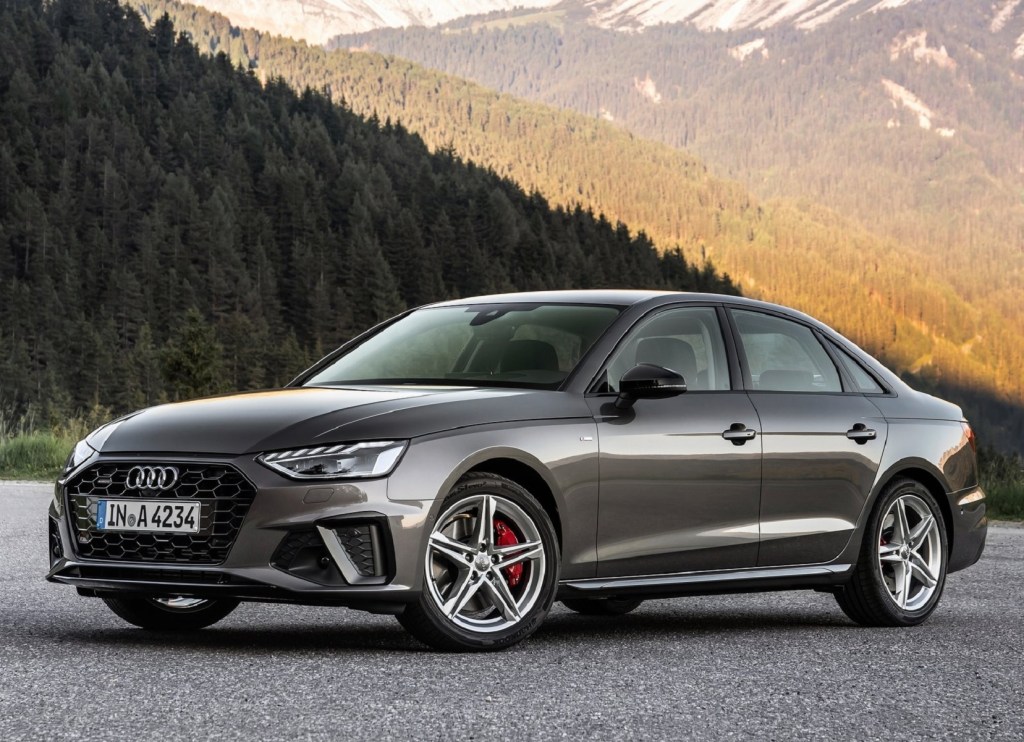 a 2020 Audi A4 parked on gravel in front of the mountains