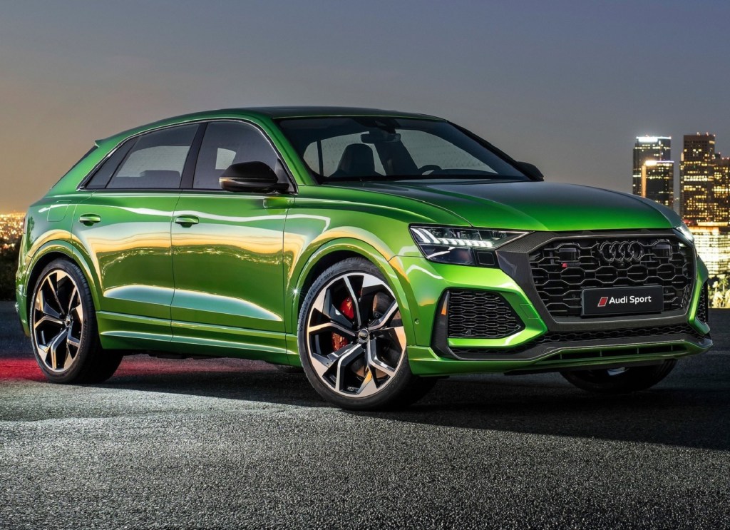 A green 2020 Audi RS Q8 front 3/4 in front of a city scene