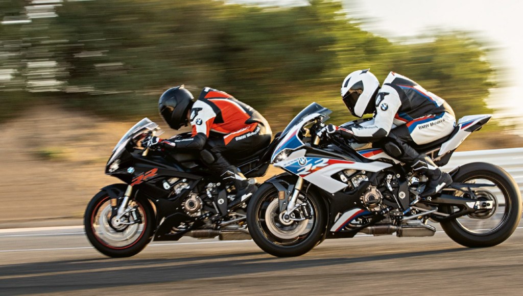 2 riders on a black and a white-red-and-blue 2020 BMW S 1000 RR