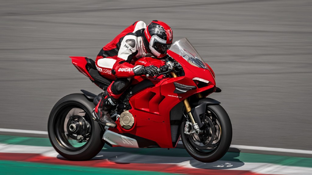 A rider on a red 2020 Ducati Panigale V4 S at the track