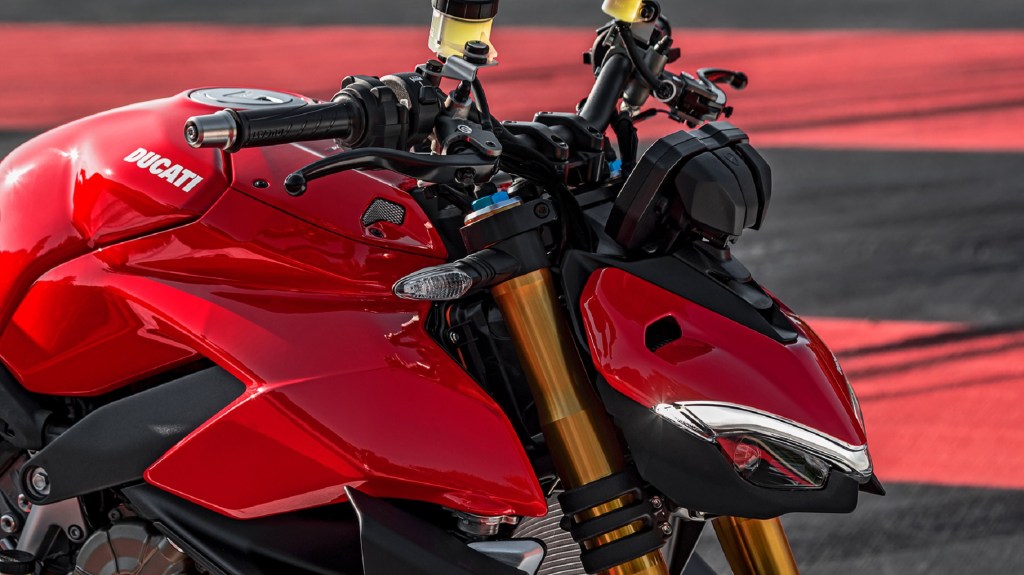 A close look at a red 2020 Ducati Streetfighter V4 S' handlebar and dash area