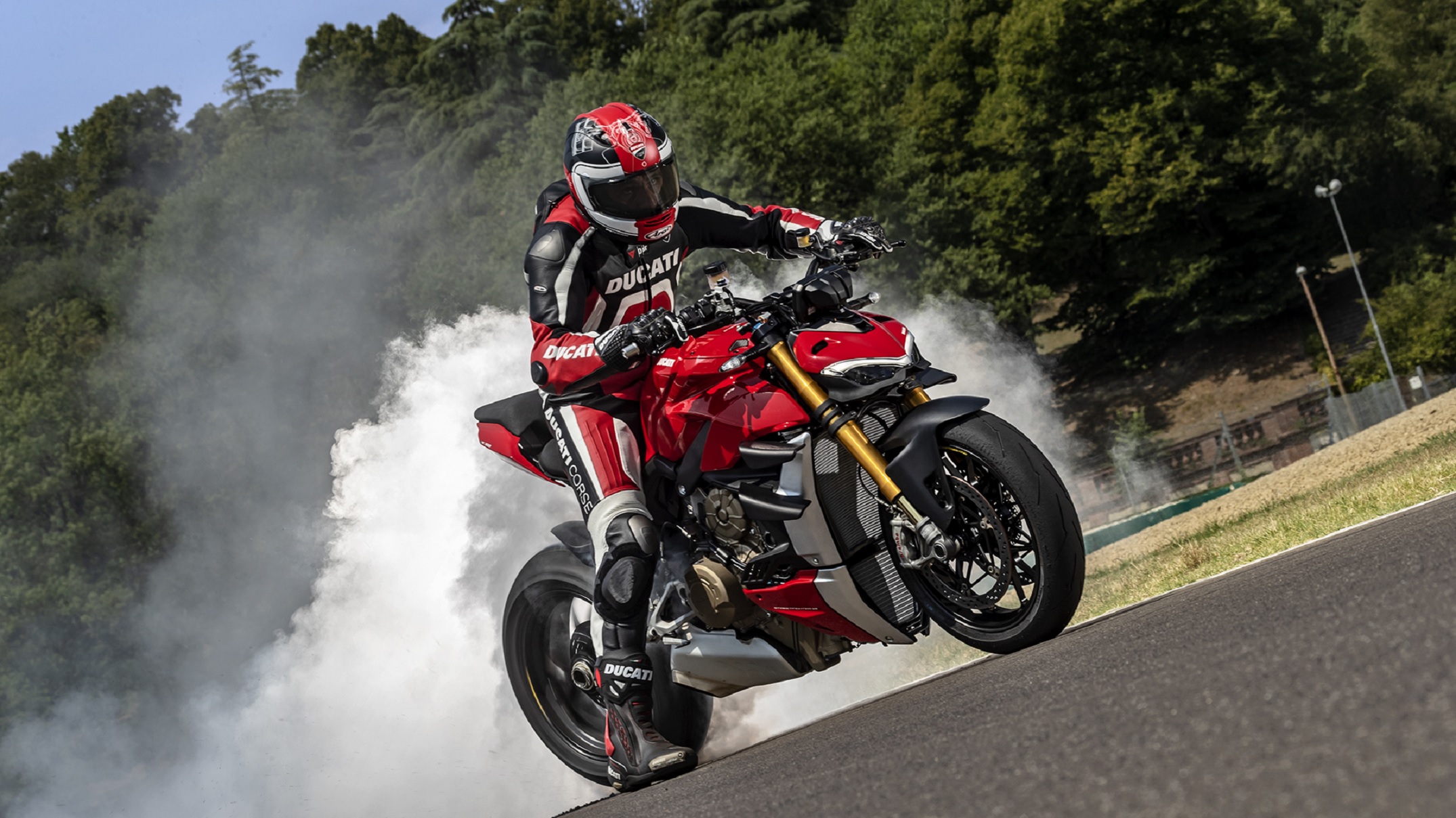A rider does a burnout on a red 2020 Ducati Streetfighter V4 S
