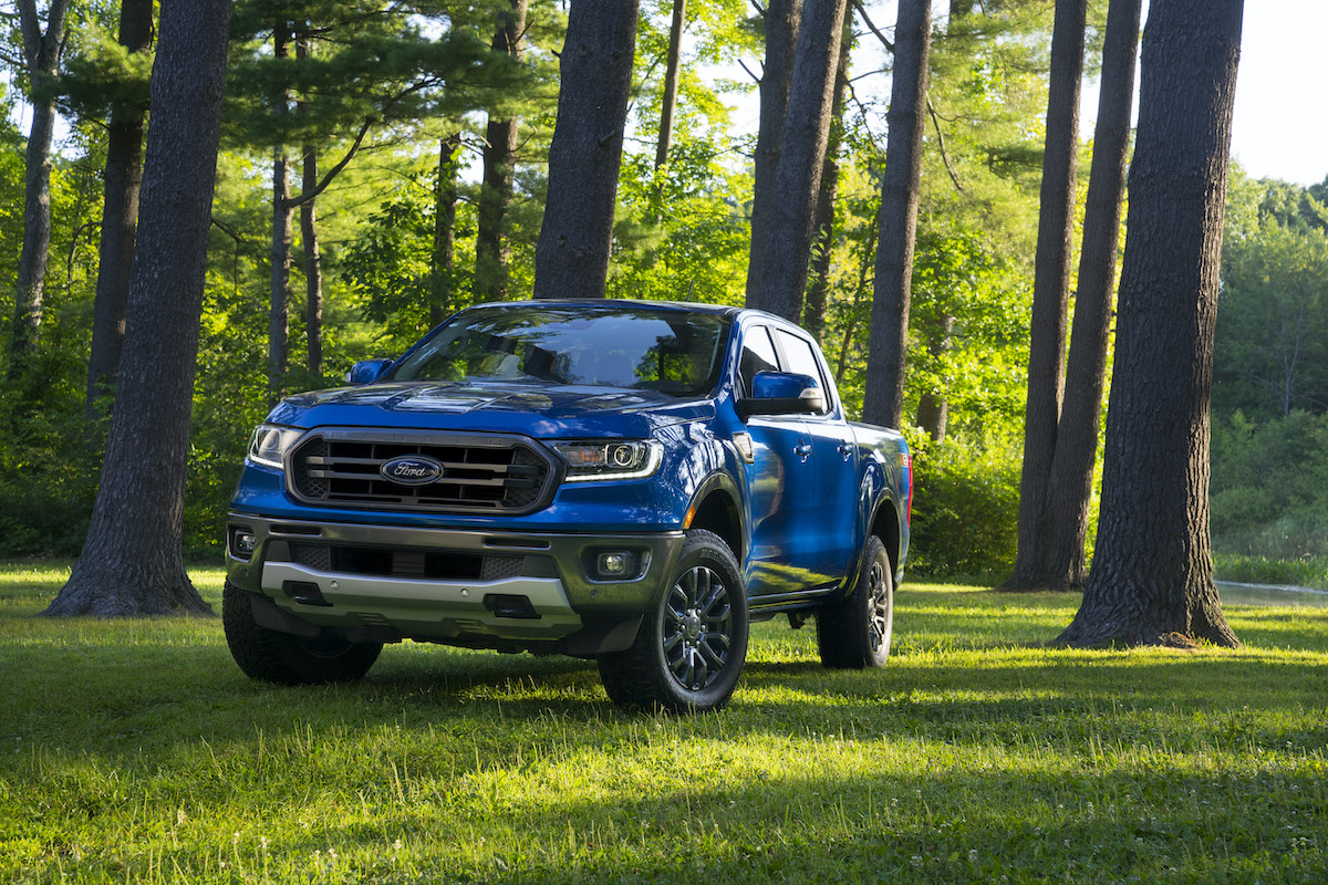 2020 Ford Ranger driving in the forest with lush green grass