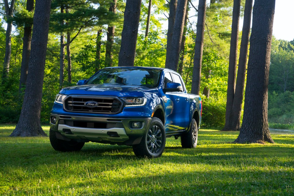 2020 Ford Ranger pickup truck driving in the forest with lush green grass