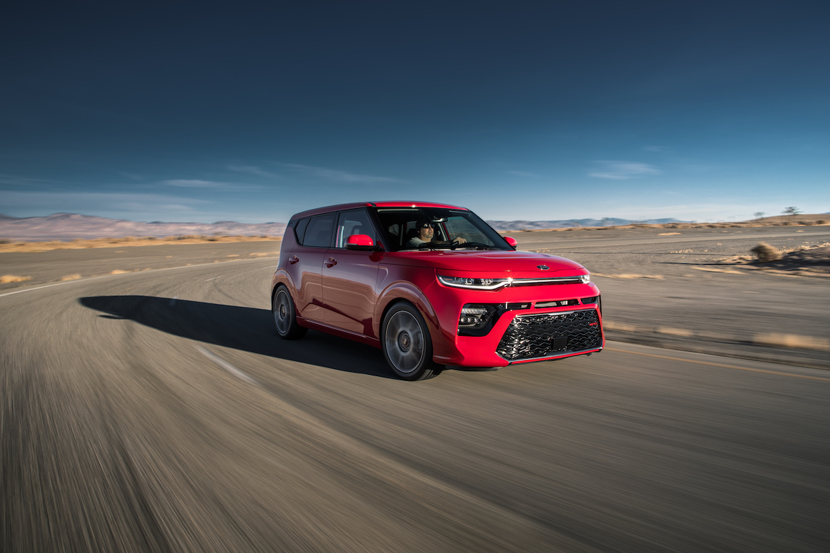 2020 Kia Soul GT-Line in inferno red driving on a track with a blue sky