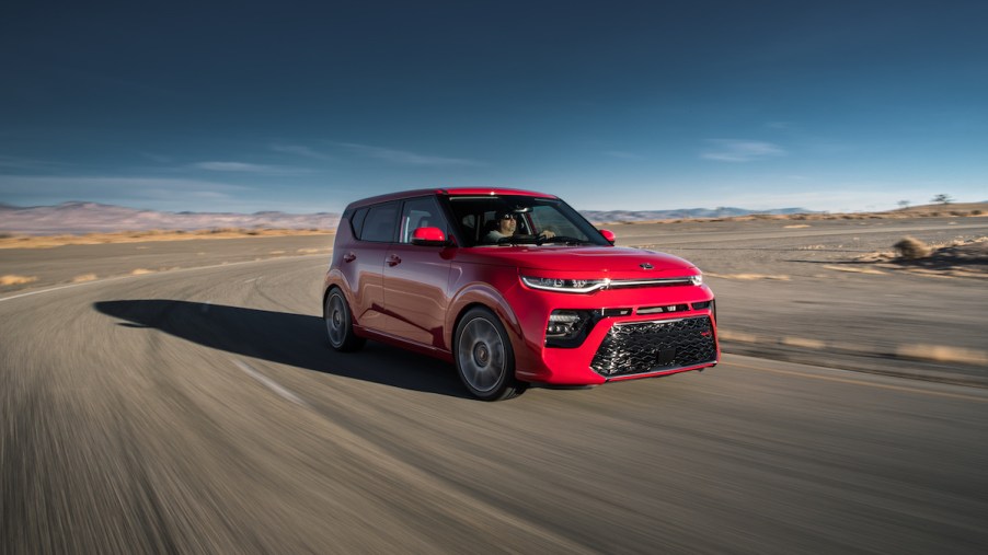2020 Kia Soul GT-Line in inferno red driving on a track with a blue sky
