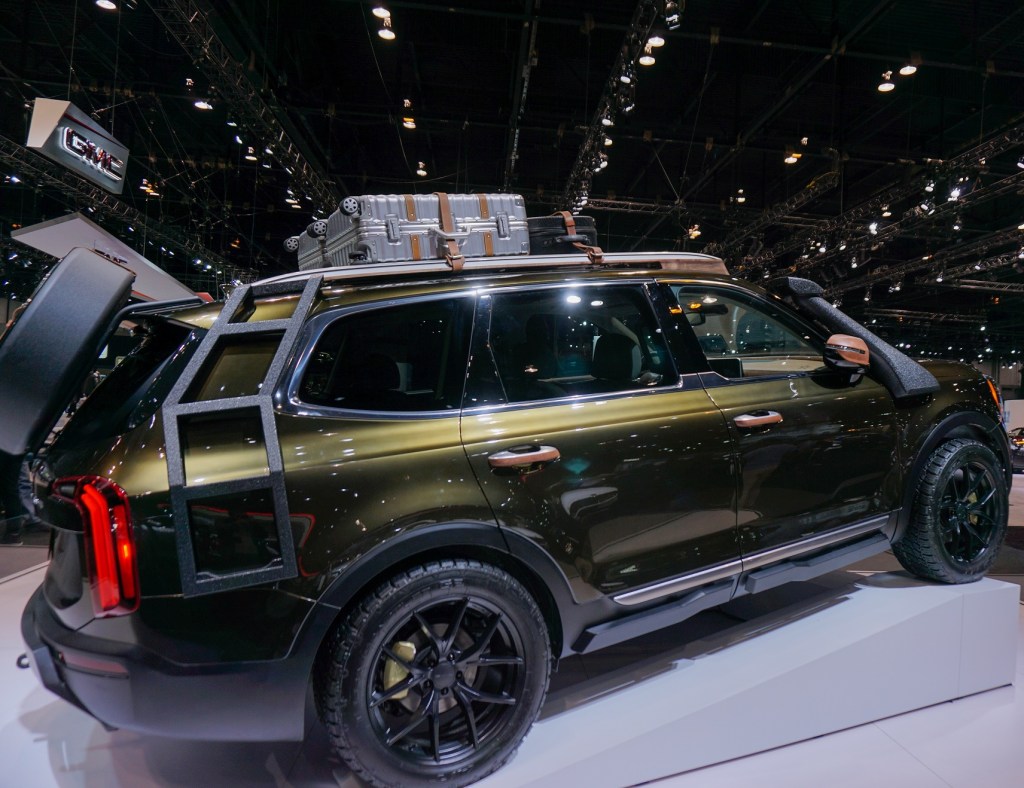 The side view of a dark-green 2020 Kia Telluride originally modified for NY Fashion Week