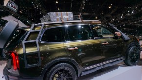 The side view of a dark-green 2020 Kia Telluride originally modified for NY Fashion Week