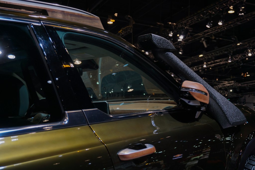 A closer look at the dark-green 2020 Kia Telluride NY Fashion Week's leather-covered mirrors and black snorkel