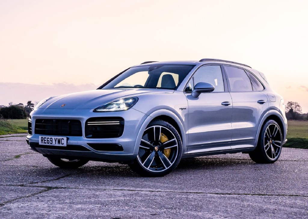 A grey Porsche Cayenne off-roading on the beach.