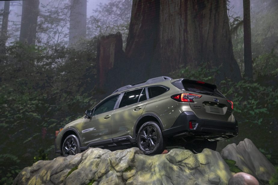 2020 Subaru Outback displaying capability with staged photo on top of a cliffside