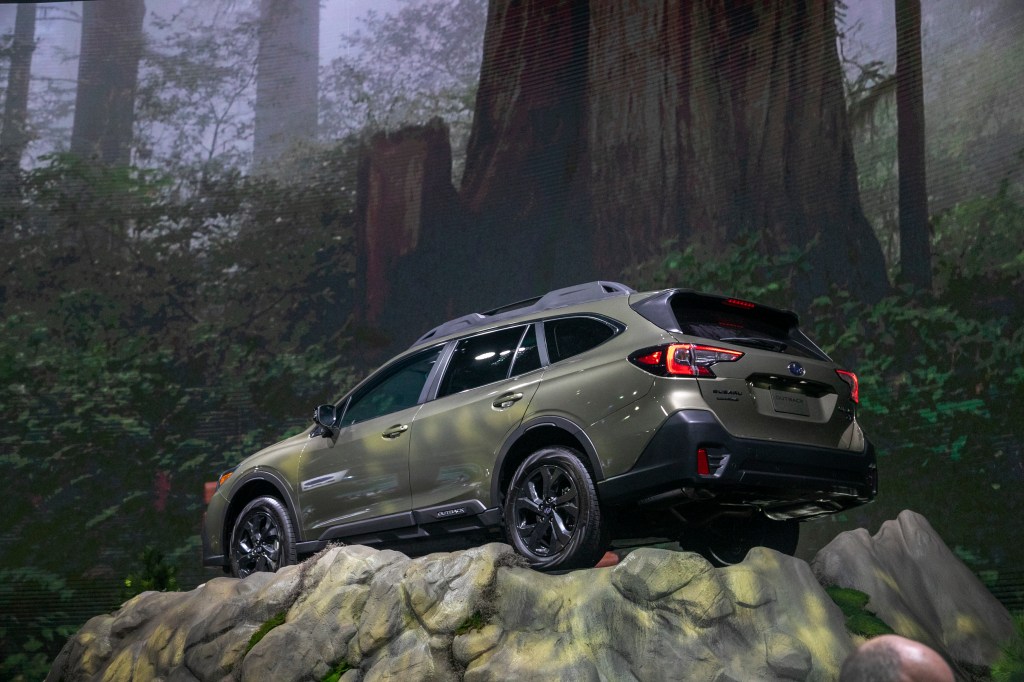 2020 Subaru Outback displaying capability with staged photo on top of a cliffside