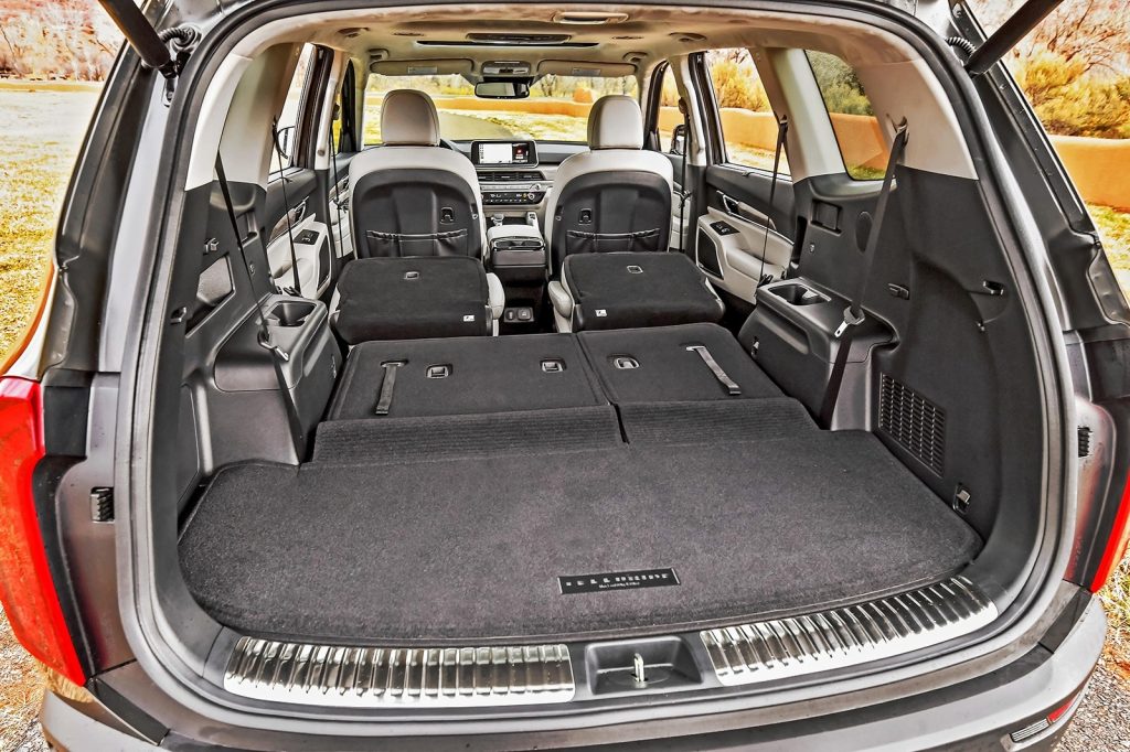A rearview of the 2020 Kia Telluride midsize crossover SUV with its back row seats folded down.