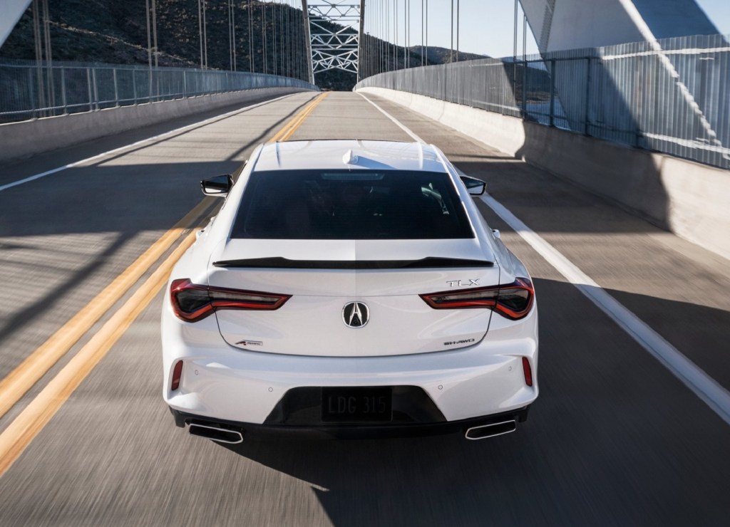 The rear view of a white 2021 Acura TLX A-Spec AWD on a bridge