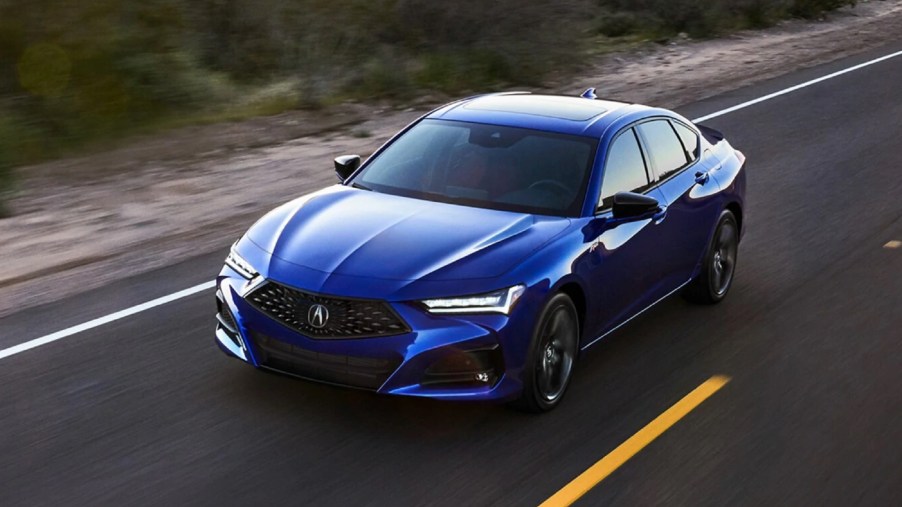 A blue 2021 Acura TLX A-Spec drives down the road