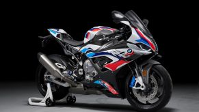 A white-red-and-blue 2021 BMW M 1000 RR on a rear-wheel stand