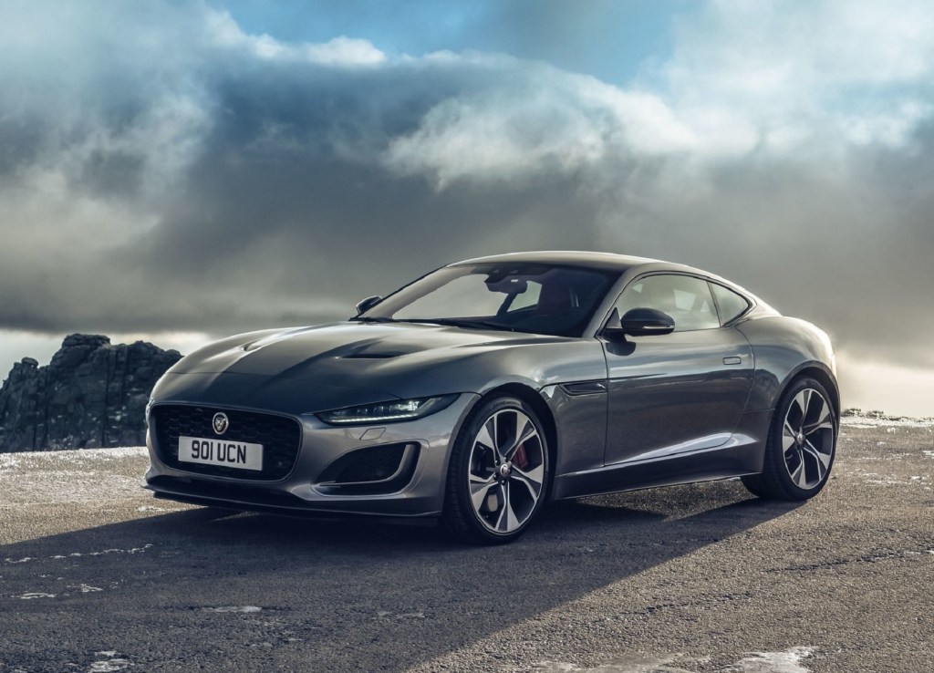 A gray 2021 Jaguar F-Type Coupe in front of the ocean