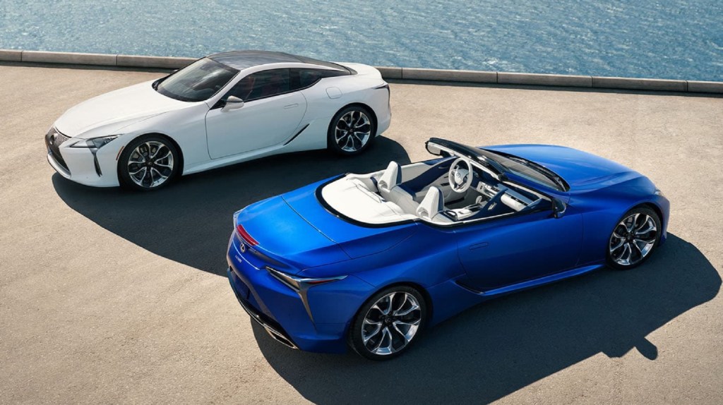 A white 2021 Lexus LC500 Coupe above a blue 2021 Lexus LC500 Convertible parked by the sea