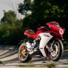A red-and-white 2021 MV Agusta Superveloce 800 on a tree-lined racetrack