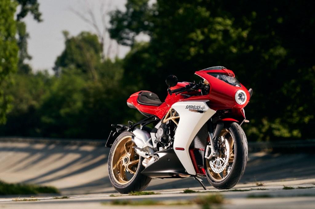 A red-and-white 2021 MV Agusta Superveloce 800 on a tree-lined racetrack