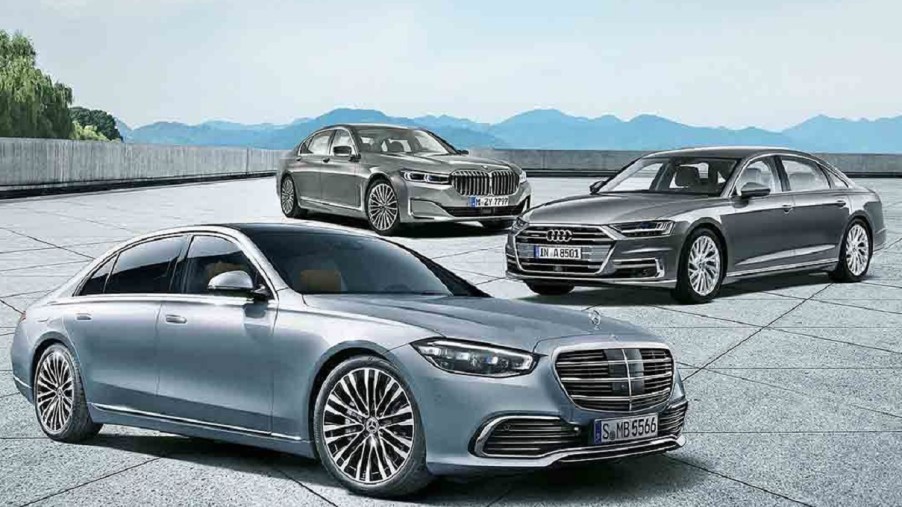 A light-blue 20201 Mercedes S-Class in front of a silver 2020 Audi A8 L in front of a gray 2020 BMW 7 Series