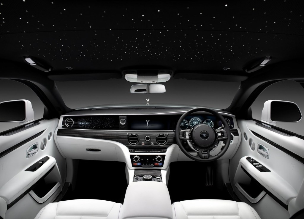A white-leather-upholstered 2021 Rolls-Royce Ghost's interior, showing the LED-lit headliner