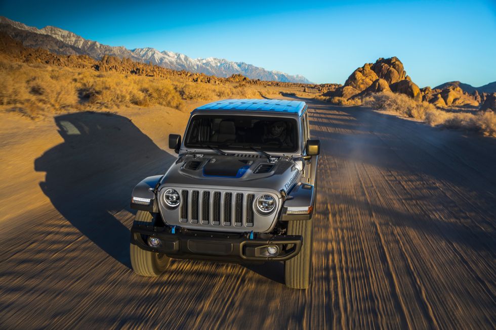 2021 Jeep Wrangler 4xe driving on dirt road