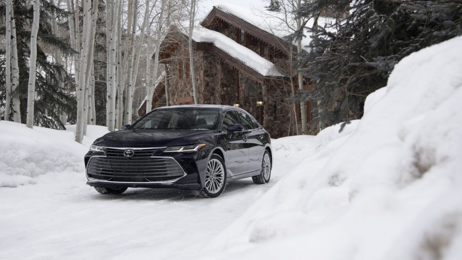 A 2021 Toyota Avalon with AWD driving through snow.