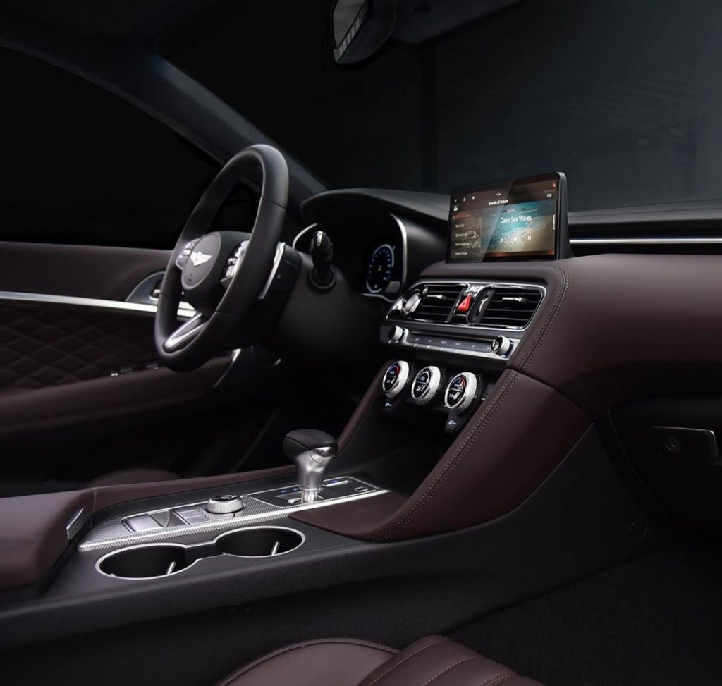 The dark-brown-leather-upholstered interior of the 2022 Genesis G70