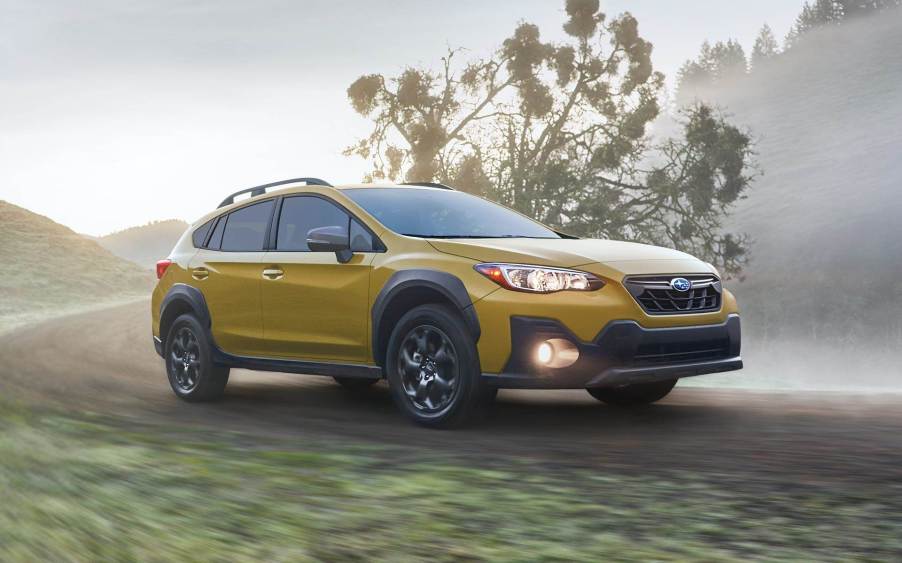 A yellow 2021 Subaru Crosstrek Sport on a foggy field