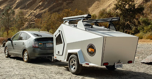 A Toyota Prius hauling a Polydrop RV camper.