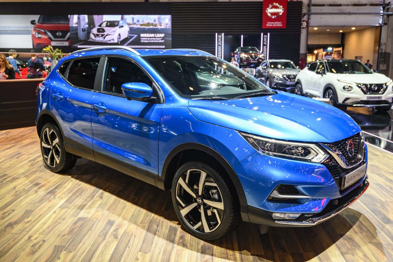 A blue Nissan Rogue on display at an auto show