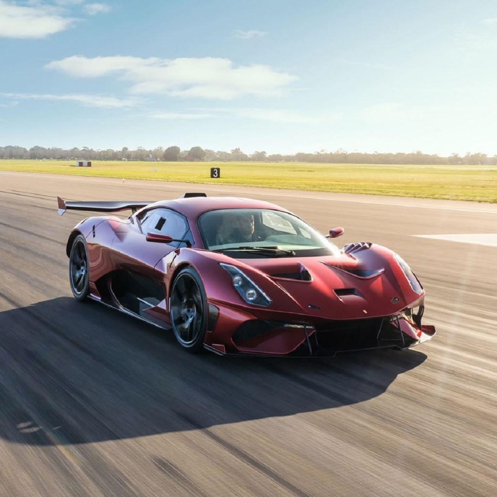 A red Brabham BT62R races down a runway