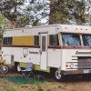 the Mander, Jessy's vintage RV set up in the woods for some time spent in nature