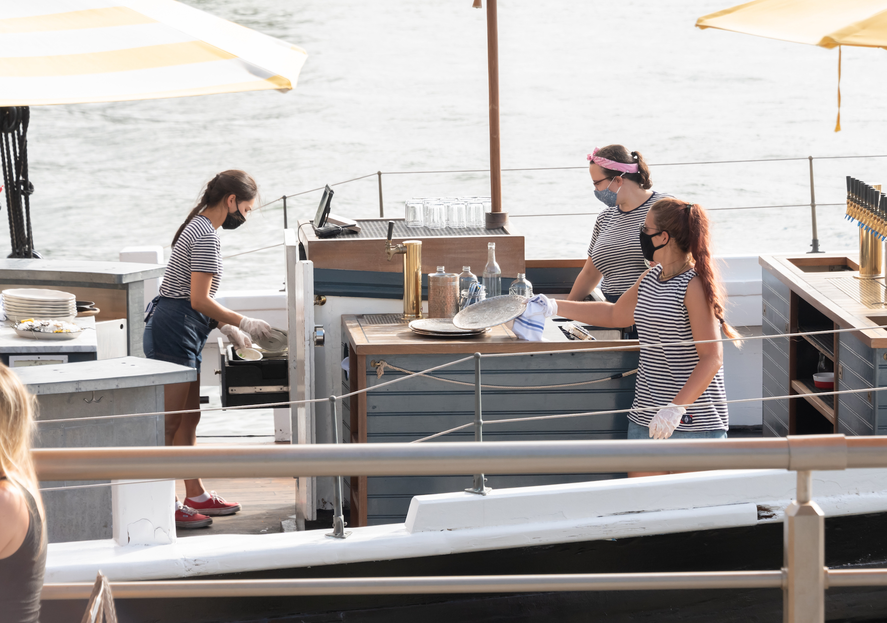 Bartenders work on the Grand Banks boat restaurant at Pier 25 as the city continues Phase 4 of re-opening following restrictions imposed to slow the spread of coronavirus