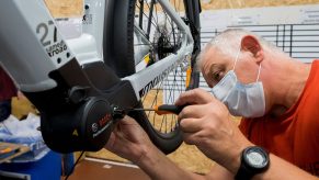 An employee assembles an electric bike at a shop