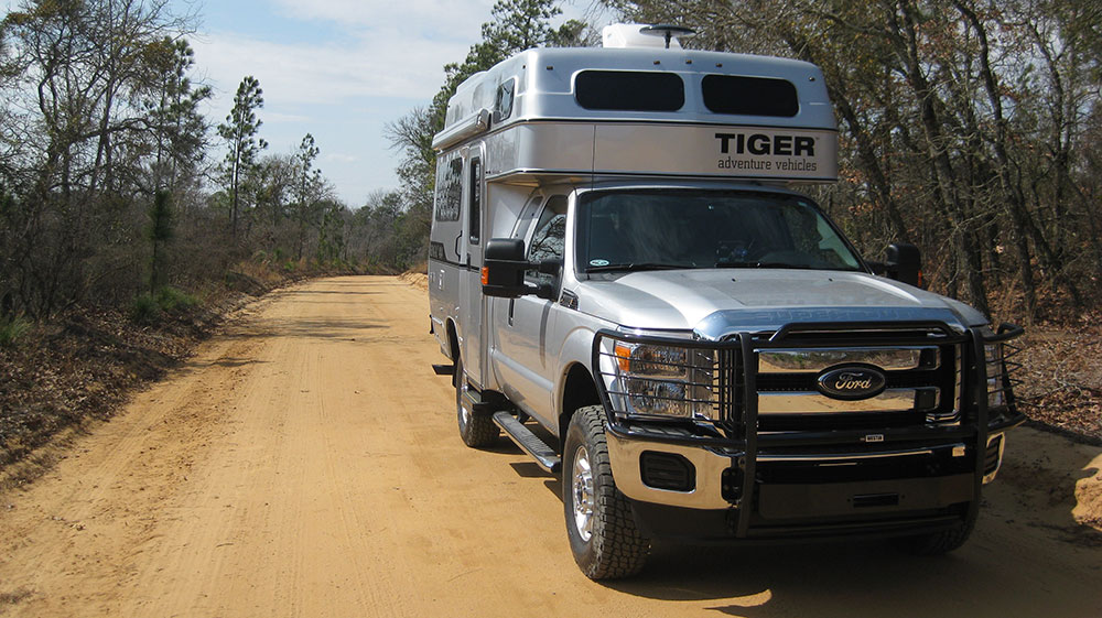 Bengal off-road pickup truck RV by Tiger Adventure Vehicles on a dirt road