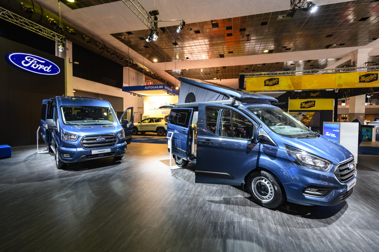 Ford Transit camper vans on display at an auto show