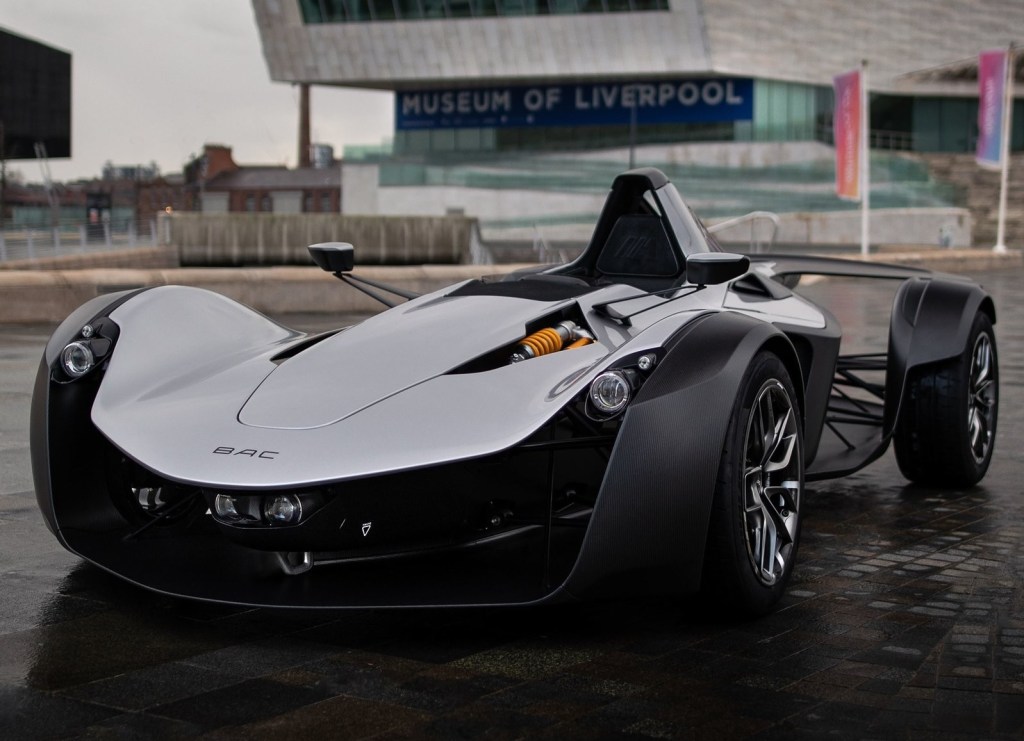 A gray Gen 2 BAC Mono in front of a racetrack facility