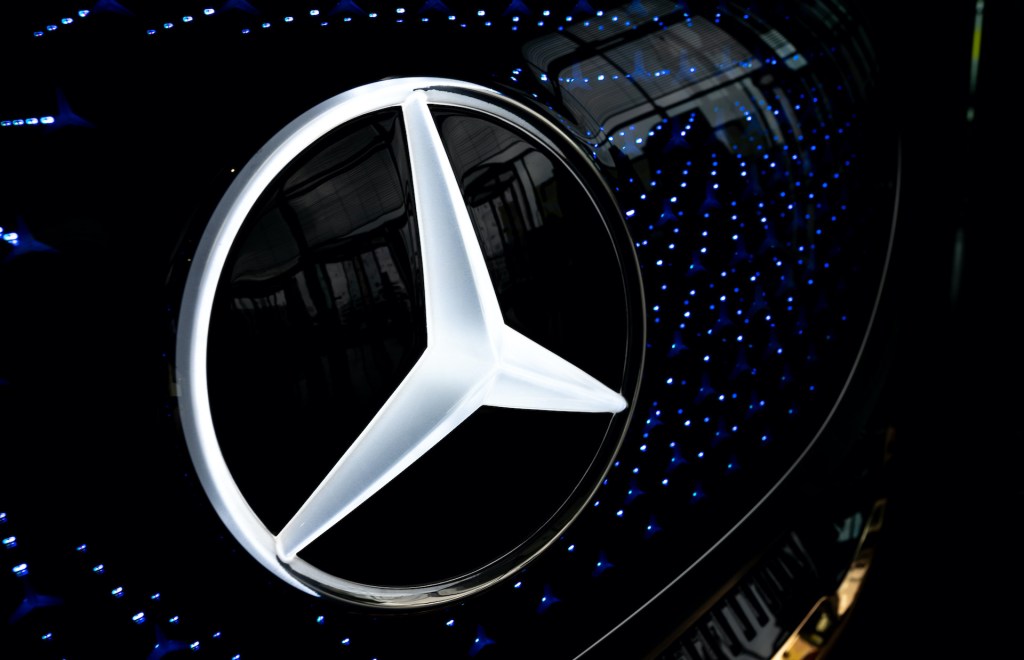 A photo of the Mercedes three-pointed star logo.