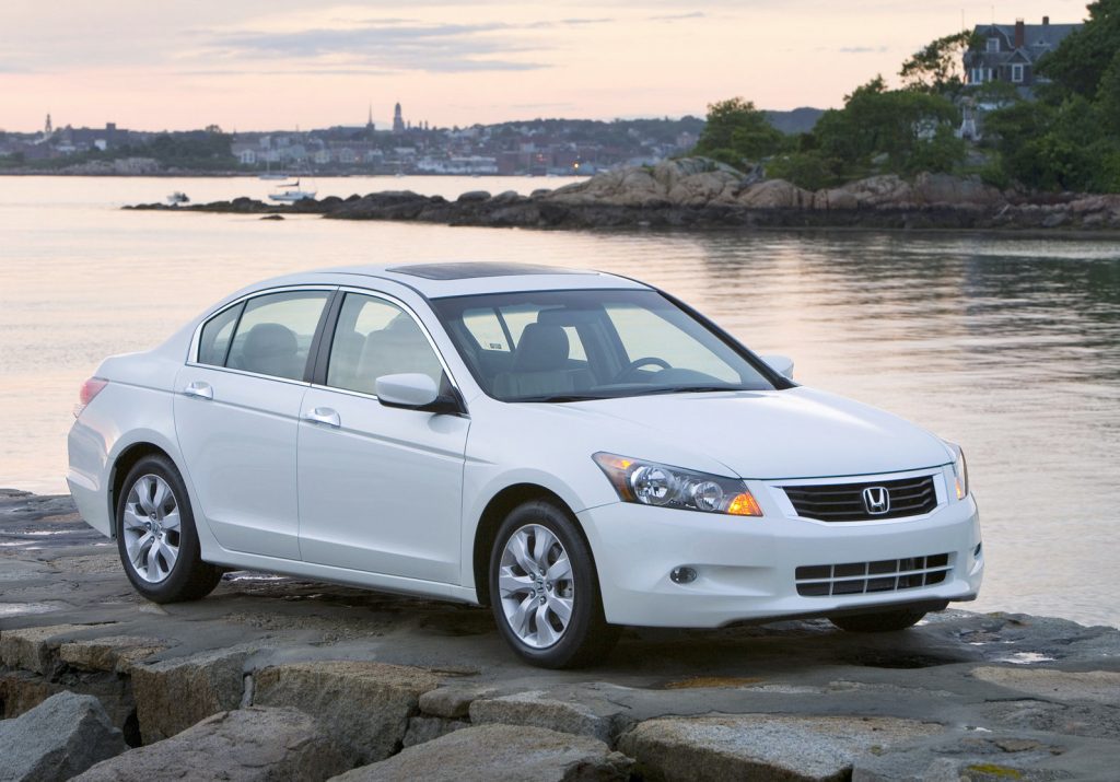 a white 2008 honda accord parked by the shore