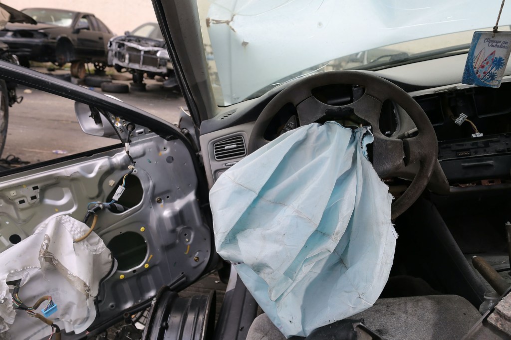 A deployed airbag is seen in a 2001 Honda Accord