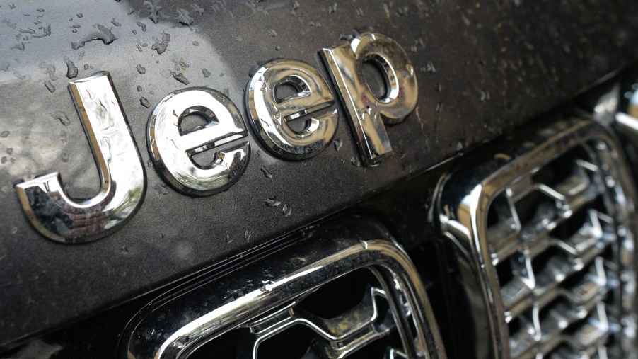 Close-up of the Jeep logo above the iconic seven-slot grille of a Jeep SUV
