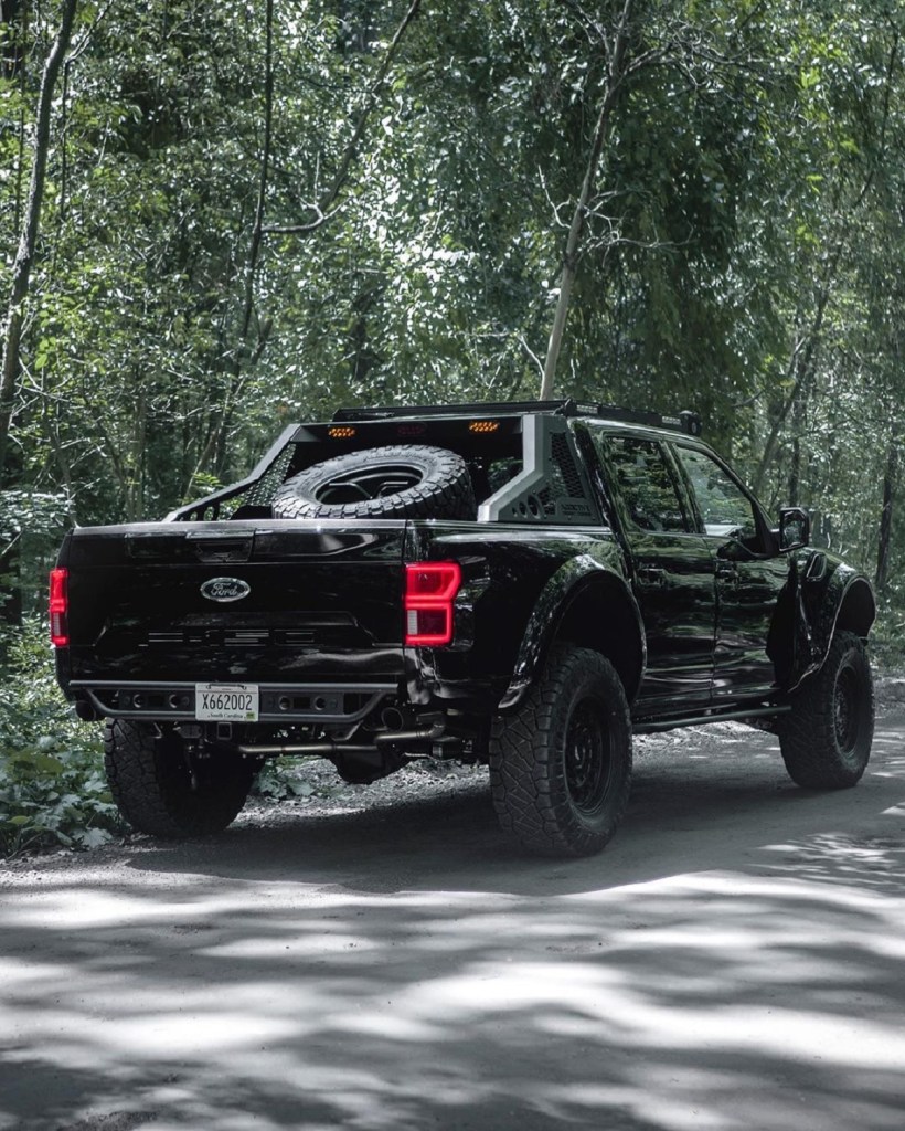 The rear view of a black Mil-Spec supercharged Intrepid Ford F-150