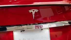 American electric vehicle and clean energy company Tesla logo seen on a Model S vehicle, now competing with the Lucid Air Dream..