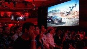 An audience watches debut footage of the PS4 video game Need for Speed Payback at E3.